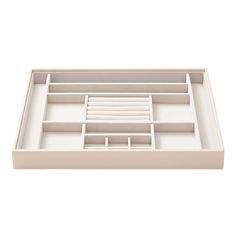 an open drawer with white drawers on the bottom and one section in the middle that is empty