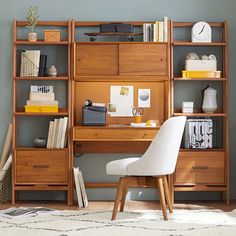 a chair and desk in front of a bookshelf