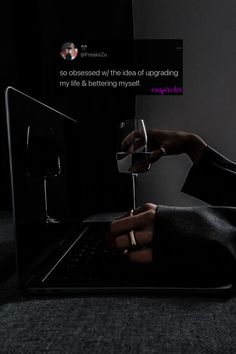 someone is drinking from a wine glass in front of a laptop screen with the caption