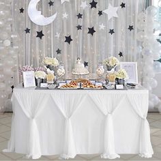 the dessert table is decorated with white and black stars