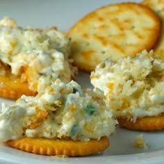 some crackers and cheese on a white plate