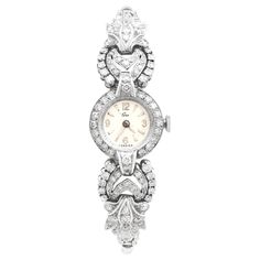 An exceptional, stunning, fine and impressive vintage 2.96 carat diamond (total), platinum and 9 karat white gold cocktail watch; part of our vintage watch collections. This stunning ladies vintage cocktail watch has been crafted in platinum and 9k white gold. This 1950s wristwatch has a classic circular, geometric Art Deco style design. The round 'antique white', textured watch face displays the maker's mark Ciro in addition to silvered Arabic numerals 3,6,9 and 12; the remaining hour markers d Cocktail Watch, Retro Watches, Antique Bracelets, Vintage Omega, Bracelet Display, Gold Cocktail Ring, Gold Cocktail, Vintage Cocktail, Classic Watches