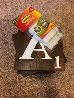 two pieces of wood sitting on top of each other with the letter a in it