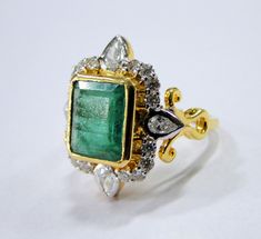 18 K gold Emerald and Diamond set ring. USA ring size-7.5 ( we can adjust size). Size of top-2.2/1.9 cm, weight-7.820 grams, emerald weight-4.36 carats, Diamond weight-1.01 carat. Diamond quality -VS GH Quality. Gold Emerald Ring With Rectangular Stone, Vintage Gold Emerald Ring With Rose Cut Diamonds, Gold Emerald Ring With Rectangular Stone For Formal Occasions, Rectangular Gold Rings With Rose Cut Diamonds, Elegant Green Rectangular Signet Ring, Gold Emerald Cut Hallmarked Emerald Ring, Antique Emerald Ring With Rose Cut Diamonds, Antique Emerald Cut Yellow Gold Emerald Ring, Gold Emerald-cut Emerald Ring With Rose Cut Diamonds