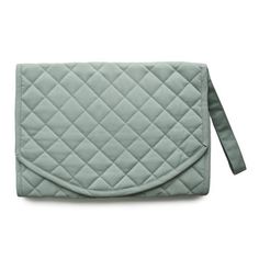 a green quilted purse sitting on top of a white surface