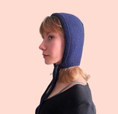 "Pure wool adult bonnet in midnight blue One of the headgear trends of 2023 is hand-knit bonnets. They have been lovely head-wear pieces of 19th century and nowadays they take place on the modern fashion world. These knitted bow-tie hoods are cozy head accessories for cottage-core style lovers. 🌿 This adult bonnet is hand knitted with pure merino wool, a luxurious and soft material that will keep you warm and comfortable in cold weather. The breathable wool material makes it perfect for outdoor activities or everyday wear. This bow tie bonnet is designed to fit snugly over the head. Whether you're running errands, hiking, or just lounging at home, this hand knit bonnet is sure to become a go-to accessory in your winter wardrobe. 🌿 Don't forget to check all my \"Knit Bonnet\" section to s Blue Balaclava, Knitted Bow, Knit Bonnet, Cottage Core Style, Gender Free, Head Wear, Tie Length, Head Accessories, Fashion World