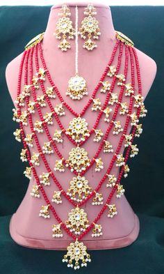 Kundan Long Red 5 Layers Necklace Earrings Tika Pearls Jewelry, Gold Plated Indian Jewelry, Bridal Wedding Handmade Jewelry Unique Set ITEM DESCRIPTION Metal = Gold Plated Occasion = Wedding ,Party Wear, Bridal Color = White and Red Size = Necklace Length = 36 CM Earrings/Studs = 7 CM Tika = 10 CM 100% Satisfaction Guarantee: 1 Year Warranty, Long Lasting Plating, High-Quality Stones Occasion: Perfect choice for any Indian occasion. Care: It is advisable that you keep products away from direct h Red Chandbali Bridal Necklace For Wedding, Red Bridal Earrings For Festive Wedding, Red Bridal Earrings For Wedding, Festive Red Bridal Earrings For Wedding, Red Kundan Bridal Sets With Stone Work, Red Tilla Jewelry For Marriage, Red Stone Work Bridal Sets For Wedding, Traditional Red Chandbali Bridal Sets, Red Temple Jewelry Bridal Earrings For Wedding