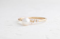 Add a touch of sophistication with our Pearl Fleurette Ring. Its delicate design features a lustrous pearl accented by sparkling diamonds for a timeless, feminine charm. All sizes will be made to order. Delicate Design, Sparkle Diamonds, Guinea Bissau, Mozambique, Trinidad And Tobago, Kenya, Design Features, Diamonds, Yellow Gold