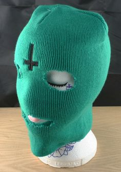 This is a green balaclava as seen in the music video to she and worn on tour by tyler the creator of ofwgkta.  Made from same hat as the original but with a high quality professionally embroidered cross on the forehead designed to look sketchy & hand done like the original but with the permanence of embroidery. Ideal for dress-up or just to get though the up coming cold winter with a little SWAG This is not an official Odd Future product. It was made by myself. Item sent within 3 working days of Casual Balaclava Beanie For Streetwear, Casual Balaclava For Streetwear, Casual Streetwear Balaclava, Winter Streetwear Balaclava Mask, Casual Full-face Balaclava, Casual Green Balaclava For Outdoor, Winter Streetwear Balaclava, Casual Hooded Balaclava For Streetwear, Green Full Face Balaclava For Outdoor Use