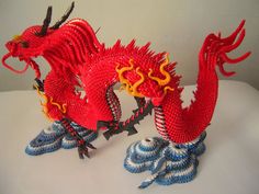 two red dragon figurines sitting on top of each other