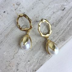 This Pair Of Elegant Golden Hoop And Pearl Earrings Have A Clean & Classic Look. A Slightly Irregular Gold Circle, With A Post Back, Has Small Waves And Grooves Which Catch Lots Of Light. It Sits On The Bottom Of The Ear Lobe With Its Post Back. The Tulip Shaped Pearl Is Free To Sway Below And Has A Beautiful Iridescent Sheen. Gold Plated, Faux Pearl, Ear Backs Included. Approx. Size: 1-1/2" L, 5/8"W Brand New Item, Handmade Jewelry By: Jpeace Designs Everyday Earrings, Classy, Trendy Chic White Teardrop Hoop Earrings, White Metal Teardrop Earrings With Pearl Drop, White Teardrop Pearl Earrings, Spider Earrings, Bamboo Earrings, Beaded Tassel Earrings, Heart Shaped Earrings, Gold Circle, Beaded Drop Earrings