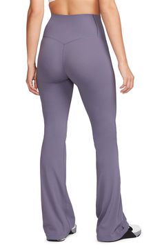 These subtly flared leggings boast signature moisture-wicking tech to keep you moving comfortably. 32" inseam, 19" leg opening; 9 1/2" front rise; 13" back rise (size Medium) Elastic waist Dri-FIT moisture-wicking technology 63% nylon, 37% spandex Machine wash, line dry Imported Moisture-wicking Fitted Wide Leg Yoga Pants, Fitted Wide Leg Moisture-wicking Yoga Pants, Moisture-wicking Fitted Wide-leg Yoga Pants, Stretch Nike Yoga Pants, Flare 4-way Stretch Sports Bottoms, Flared Sports Bottoms With 4-way Stretch, Sporty Flare Activewear For Gym, Sporty Flare Activewear For Workout, Flare Athleisure Yoga Pants For Sports