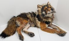 a stuffed wolf laying on top of a white floor