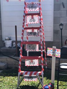 a ladder decorated with red and white striped paper