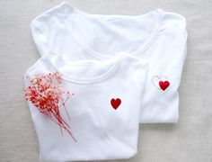 White T-shirt Small Heart T-Shirt White Red Heart Women T-shirt Little Heart T-shirt Red Heart Tshirt Birthday Gift Mother Day Birthday Gift ROUND COLLAR White T-shirt regular cut and breathable material. Soft and comfortable 100% cotton composition and its well-fitted cut. ✅ You can choose the color of glitter heart The heart size is 4,5 cmx 4,5 cm (1,7 inch x 1,7 inch ) for two hearts print  The heart size is 3,8 x 4 cm  (1,5 inch x 1,6 inch ) for one heart print  If you need a larger or small Valentine's Day Graphic Tee T-shirt Gift, White T-shirt With Heart Print For Mother's Day, White Heart Print T-shirt For Mother's Day, Red T-shirt For Valentine's Day Gift, Red Short Sleeve T-shirt For Gift, White Tops For Valentine's Day Anniversary, Crew Neck T-shirt With Heart Graphic As Gift, Heart Print Crew Neck T-shirt For Gift, Red Crew Neck Top For Gift