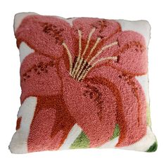 a pink flower pillow on a white background