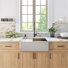 a kitchen with marble counter tops and wooden cabinets, along with an open window that looks out onto the outdoors