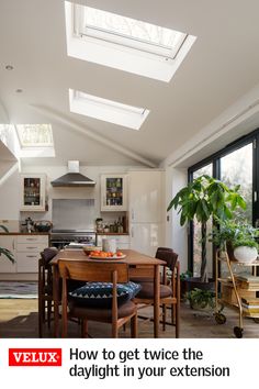 an image of a kitchen with skylights above the table and chairs in front of it