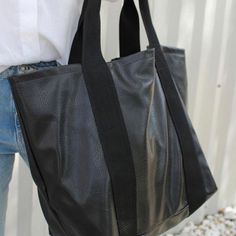 Visiting a friend on a different college campus? Headed to the beach or home for the weekend? The Weekender Tote is the perfect bag option for you. With a zipper at the top and pouch on the inside- you can fit all your necessities in one bag for the weekend. $188 17" tall x 26" wide x 10" deep Trendy Black Weekend Bag, On-the-go Coated Canvas Backpack, Versatile Canvas Tote Bag With Zipper, Versatile Canvas Tote Bag With Zipper Closure, Practical Bag With Zipper Closure For On-the-go, Black Shoulder Bag For Weekend, Trendy Black Shoulder Bag For Weekend, Black Weekend Bag With Adjustable Strap, Large Capacity Canvas Shoulder Bag For Weekend