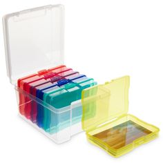 four plastic storage boxes with lids and dividers on the sides, each containing different colored sections