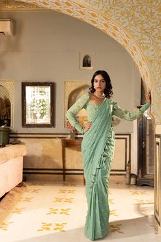 Pre draped Mirror work saree with tassels. The blouse is smoked. It can be worn as an off shoulder or with shoulders.
– Non padded
– Saree is lined. Traditional Dupatta With Draped Sleeves For Reception, Traditional Fitted Dupatta With Draped Sleeves, Traditional Blouse With Draped Sleeves, Elegant Green Pre-draped Saree For Transitional Season, Traditional Drape Saree With Draped Sleeves For Diwali, Traditional Blouse With Draped Sleeves For Reception, Designer Bollywood Saree With Draped Sleeves, Diwali Saree With Draped Sleeves In Traditional Drape, Diwali Saree With Draped Sleeves And Traditional Drape