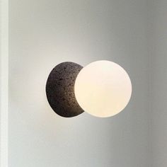 two lights that are next to each other in a room with white walls and flooring