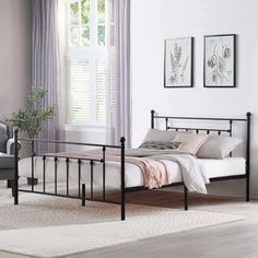 a black metal bed frame in a bedroom