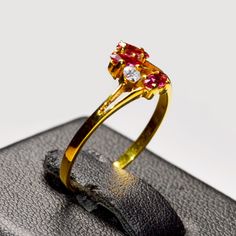 Natural Pinkish Red Ruby Anniversary Ring {Natural African Ruby} Dimension Of the stones {Ruby} : 2x4 Marquise shape 3Pcs 0.42 Ct total weight of the stones Secondary Stones : Natural White Zircon 2.2 mm {1 Pc } Whole Ring Weight : 1.4 g. Ring Size : UK N1/2, US 7 Handcrafted with solid 9K fine Gold . The band for Girl/Women individually hand-set with 2x4 mm size stone Marquise shaped Natural Ruby July Birthstone. Total 4 Gemstones - Cluster Setting . This Ruby 9K Beautiful ring is timeless and stylish. Every piece passes rigorous inspection. So you can buy with confidence. A fantastic gift for Engagement, Anniversary Gift, Christmas's Day, Birthdays, Graduation, Valentine's Day,Mother's Day If you have any question please message us . Thanks for stopping us by. SG2022-362 Anniversary Ruby Crystal Ring In Yellow Gold, Anniversary Yellow Gold Ruby Crystal Ring, Gold Ruby Crystal Ring With Prong Setting, Yellow Gold Ruby Open Ring, Gold Ruby Ring For Promise, Antique Ruby Ring, Ruby Anniversary, Ring Ruby, Pinkish Red