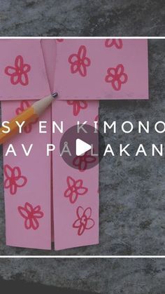 a cross made out of pink paper with the words easyen kimono ka av pakala