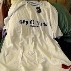 Womans "City Of Angels" T Shirt Urban Shirt With Text Print For Summer, Urban Style Shirt With Text Print For Summer, Urban Style Text Print Shirt For Summer, Urban Style White T-shirt With Letter Print, Urban White T-shirt For Streetwear, Urban White Shirt For Streetwear, White Hip Hop Shirt With Text Print, Urban White Shirt With Logo Print, Urban Text Print Shirt For Streetwear