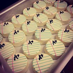 decorated cupcakes in the shape of letters and numbers are arranged on a tray