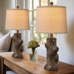 two lamps sitting on top of a wooden table