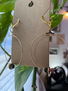 Handmade gold beaded hoops with pink and green beads Gold Brass Earrings With Colorful Beads, Brass Beaded Dangle Hoop Earrings, Bohemian Gold Beaded Circle Earrings, Brass Beaded Hoop Earrings As Gift, Beaded Brass Hoop Earrings For Gift, Gold Beaded Earrings With Colorful Beads, Gold Beaded Brass Hoop Earrings, Gold Hoop Beaded Earrings For Everyday, Everyday Gold Beaded Hoop Earrings