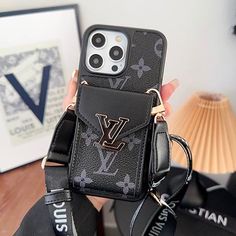 the louis vuitton phone case is in someone's hand, holding it up