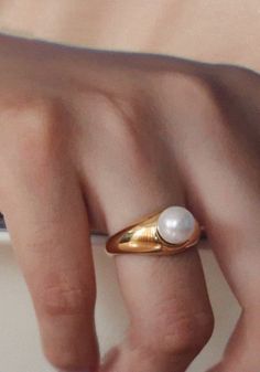 This perfect everyday gold ring features a single dainty round shell pearl. The ring is designed with a curved band. A minimalist style with a vintage feel.It complements any outfit perfectly by itself or by stacking with any statement rings, or with any other width band rings.Works well as both a men's and women's wedding band, as well as a promise ring or engagement ring, entirely unisex design.# T A GGold Pearl Ring, Pearl Statement Ring, Gold Band Ring with Pearl, Gold Stacking Ring, Stackable Ring, Thick Ring, Thin Ring, Narrow Ring, Couple Ring, Couple Band, Gold Band for him, Gold Band for Couples, Gold Stacking Ring for him, Statement Rings, Different Size Band Rings Everyday Gold Ring With Pearl Charm, Gold Minimalist Pearl Ring, Minimalist Gold Pearl Ring With Detail, Gold Everyday Pearl Ring With Pearl Drop, Pearl Rings In Gold For Women, Everyday Gold Pearl Ring With Pearl Drop, Everyday Gold Pearl Drop Ring, Everyday Pearl Open Ring, Everyday Open Pearl Ring