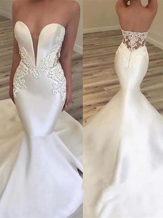 the back of a white wedding dress with lace detailing