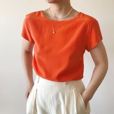 Vintage short sleeve shirt, bright orange color. Light and comfy, perfect for a summer day!  Great vintage condition, there is a rip at left armpit as shown in detail picture.  Material: 100% silk. label size XS. Model is 5'5'', 128 lbs, usually US size 5 Flat measurements: bust: 18'' (36'' around) length: 23'' Follow us on Instagram (oldgemvintage) for more choices! Please ask me about international combined shipping.  Please check the flat measurements before purchase since all sales are FINAL. Except it is mistake on my part, in which case I will refund the purchase. I do my best to examine the garments but make mistakes sometimes, please let me know if that is the case. Thank you so much!  Please note that these are vintage clothing, and they may have slight signs of wear. I try my bes Affordable Orange Short Sleeve Blouse, Orange Short Sleeve Shirt For Spring, Classic Orange Short Sleeve Shirt, Orange Solid Color Summer Tops, Orange Short Sleeve Casual Blouse, Orange Short Sleeve Solid Color Tops, Orange Casual Short Sleeve Blouse, Casual Short Sleeve Orange Blouse, Summer Workwear Plain Blouse