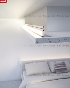 a white bed sitting under a window next to a wall mounted shelf with lights on it