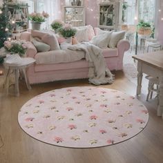 a living room with pink furniture and christmas trees in the corner, all decorated for christmas