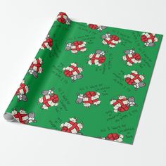 a green wrapping paper with red and white sheeps on it's sides, all over