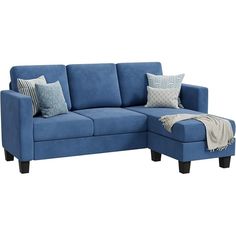 a blue sectional couch with pillows on it and a throw blanket draped over the arm