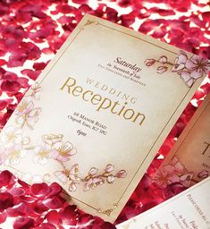 the wedding reception program is surrounded by petals