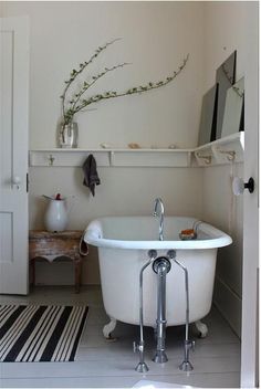 a bath tub sitting in the middle of a bathroom