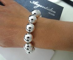 Brand: Argentidea Jewelry Instagram: https://www.instagram.com/gioielli_argentidea/ Size: 21cm (19.5 to 21cm extension chain) Weight: 40g. Silver colour Classic and eye-catching women's bracelet, in 925 silver, with smooth spheres. The spheres have a diameter of 14 mm. The bracelet features an oval lobster clasp. The bracelet is the natural color of silver, manually polished to a shiny finish. A completely handcrafted jewel, conceived, designed, produced and finished entirely by hand by master goldsmiths in our laboratory in Arezzo in Tuscany. By purchasing silver jewelery directly from the manufacturer you will have an excellent weight/price/quality ratio. All our items will be shipped together with a logo jewelry box and a logo box carrier bag. All shipments will be made with internation Elegant Sterling Silver Ball Chain Bracelets, Elegant Sterling Silver Ball Chain Bracelet, Elegant Silver Bracelet With Ball Chain, Logo Jewelry, Handcrafted Silver Jewelry, Jewelry Instagram, Ball Bracelet, Silver Colour, Ball Chain