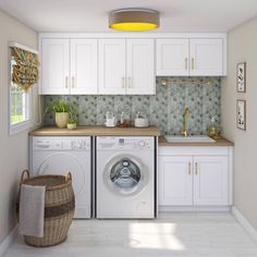 a washer and dryer in a room with white cupboards, counter tops and drawers