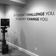 an exercise room with a wall that says if it doesn't challenge you, it doesn't change you