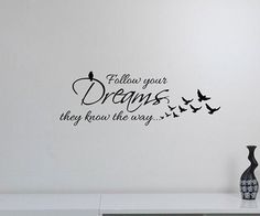 there is a wall decal that says follow your dreams, they know the way