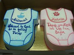 two cakes in the shape of baby's bodysuits