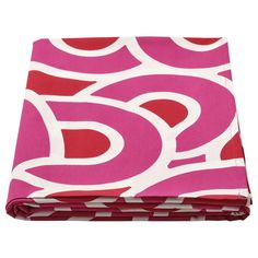 a pink and white blanket with red circles on it