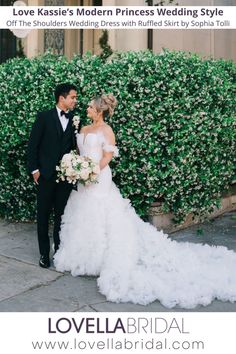 the bride and groom are posing in front of a hedge for their wedding photo shoot